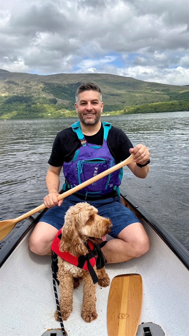 Chris Watson canoeing on calm water.